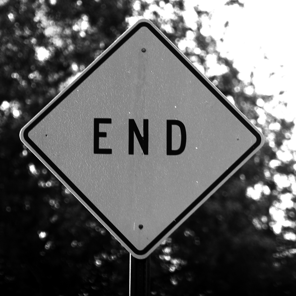 black and white end road sign